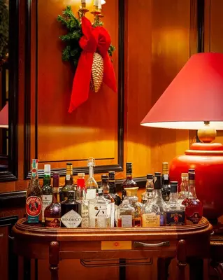 a table with many bottles of alcohol on it at NARUTIS Hotel - Small Luxury Hotels of The World in Vilnius