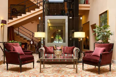 a lobby with two chairs and a coffee table at NARUTIS Hotel - Small Luxury Hotels of The World in Vilnius