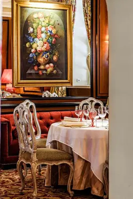 a dining room with a table with wine glasses at NARUTIS Hotel - Small Luxury Hotels of The World in Vilnius