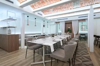 a dining room with a long table and chairs at Kaunas in Kaunas
