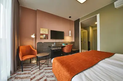 a hotel room with a bed and a desk at Kaunas in Kaunas