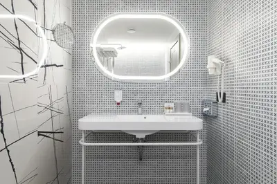 a white bathroom with a sink and a mirror at Kaunas in Kaunas