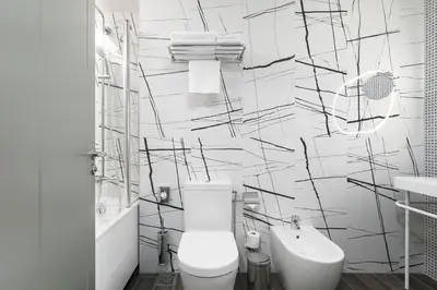 a white bathroom with a toilet and a sink at Kaunas in Kaunas