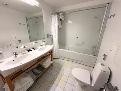 a bathroom with a sink and a toilet and a shower at BEST BALTIC Kaunas in Kaunas