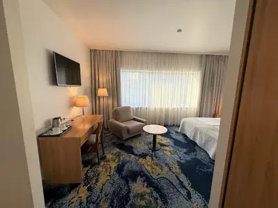a hotel room with a bed and a desk and a chair at BEST BALTIC Kaunas in Kaunas