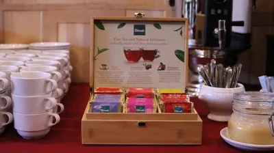 a table with cups and a sign on a table at BEST BALTIC Kaunas in Kaunas