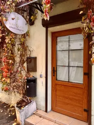 a front door of a house with a trash can at Natalex Apartments in Vilnius