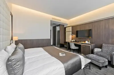 a hotel room with a bed and a desk at Congress Avenue Hotel in Vilnius