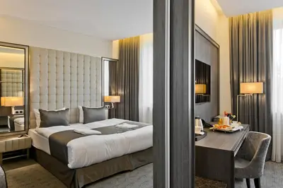 a hotel room with a bed and a desk and a desk at Congress Avenue Hotel in Vilnius