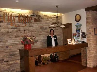 a woman standing behind a counter in a room at City Gate in Vilnius