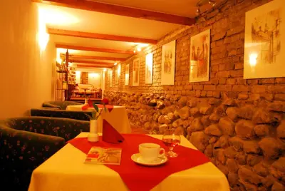 a dining room with a table with a red table cloth at City Gate in Vilnius