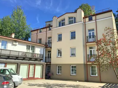 an apartment building with cars parked in front of it at City Gate in Vilnius