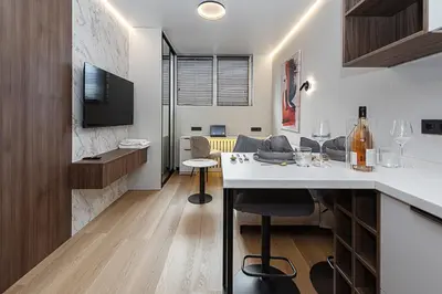 a kitchen and living room with a table and chairs at Vilnius City Hotel in Vilnius