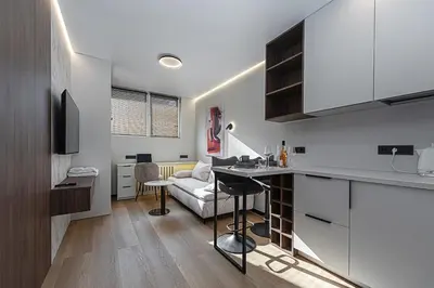 a kitchen and living room with a table and a couch at Vilnius City Hotel in Vilnius