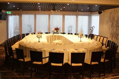 a long table in a room with chairs and a table with at Hotel Babilonas in Kaunas
