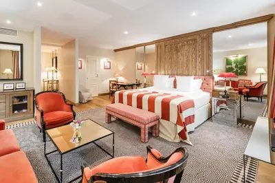 a hotel room with a bed and a living room at Stikliai Hotel - Relais & Châteaux in Vilnius
