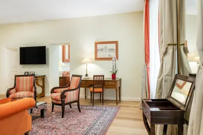 a living room with a couch and a table at Stikliai Hotel - Relais & Châteaux in Vilnius