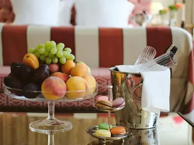 a bowl of fruit on a table with a bowl of grapes at Stikliai Hotel - Relais & Châteaux in Vilnius