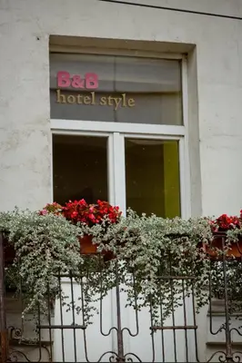 a building with a bunch of flowers in a window at In Astra in Vilnius