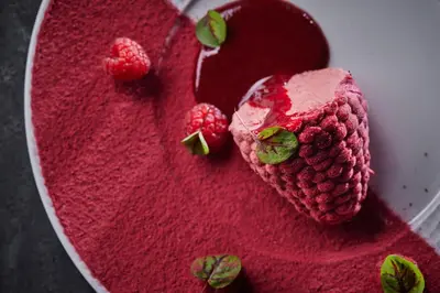 a red velvet cake with strawberries on a plate at Apvalaus Stalo Klubas Gastro & SPA Hotel in Trakai
