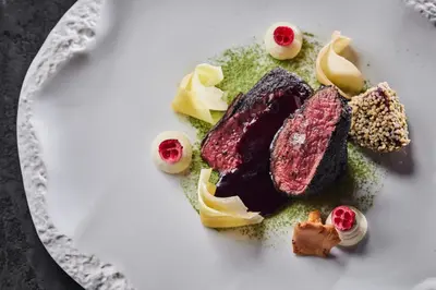 a plate of food with meat and other foods at Apvalaus Stalo Klubas Gastro & SPA Hotel in Trakai