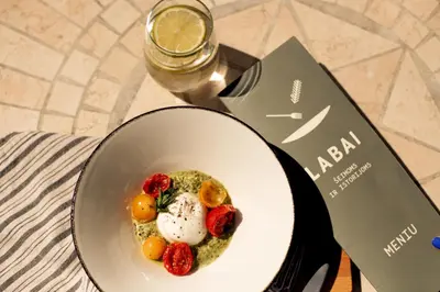 a plate of food with strawberries and eggs on a table at SPA VILNIUS Druskininkai in Druskininkai