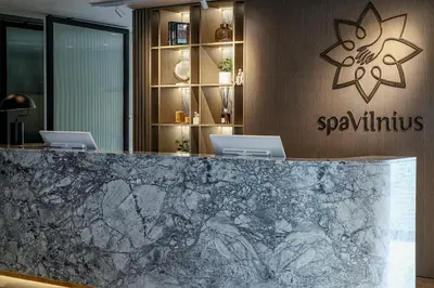 a lobby with two laptops on a marble counter at SPA VILNIUS Druskininkai in Druskininkai