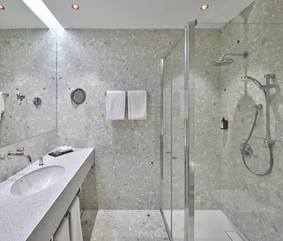 a bathroom with a shower and a sink at Neringa Hotel in Vilnius