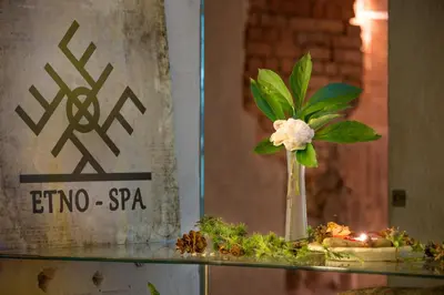 a vase with a flower on top of a glass table at Romantic Boutique Hotel & Spa in Panevėžys