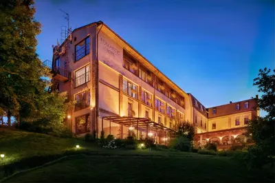 a large building with lights on the side of it at Romantic Boutique Hotel & Spa in Panevėžys