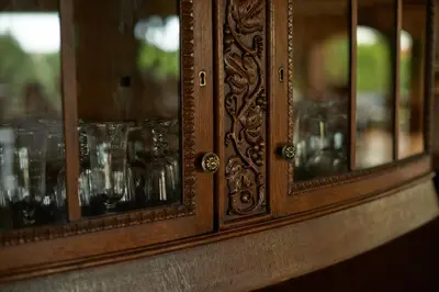 a wooden cabinet with glasses in it at Romantic Boutique Hotel & Spa in Panevėžys