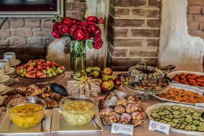 a table topped with lots of different types of food at Romantic Boutique Hotel & Spa in Panevėžys