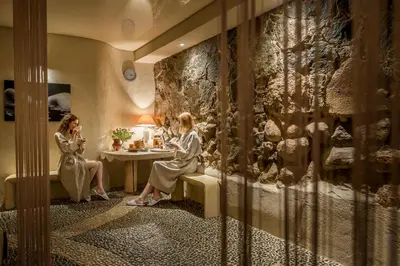 two women sitting at a table in a hotel room at Romantic Boutique Hotel & Spa in Panevėžys
