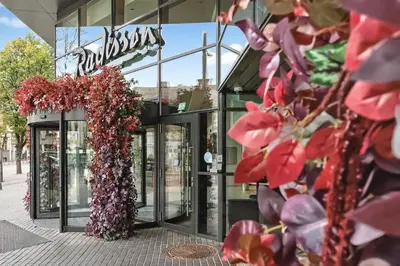 a store with a bunch of flowers on the facade at Radisson Hotel Kaunas in Kaunas