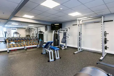 a gym with several treadmills and weights at Radisson Hotel Kaunas in Kaunas