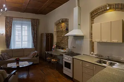 a kitchen and living room with a couch and a table at Bernardinu B&B House in Vilnius