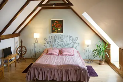 a bedroom with a large bed in a attic at Bernardinu B&B House in Vilnius
