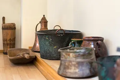 a group of old pots and pans sitting on a shelf at Bernardinu B&B House in Vilnius