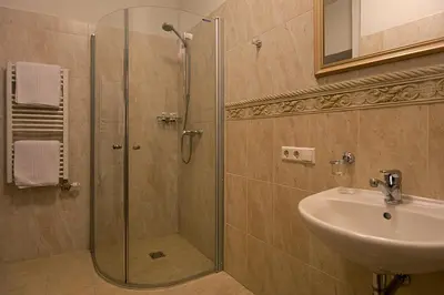 a bathroom with a shower and a sink at Bernardinu B&B House in Vilnius