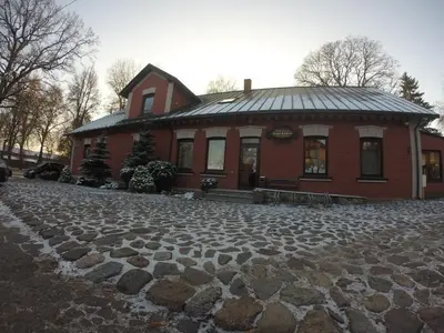 a house with a cobblestone driveway in front of a building at Grafo Zubovo Hotel & SPA in Bubiai