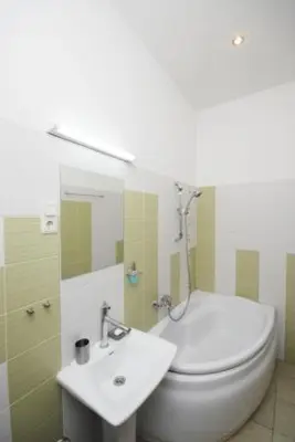 a bathroom with a white toilet and a sink at Kaunas Apartments in Kaunas