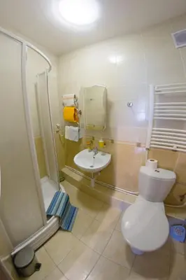 a bathroom with a toilet and a sink at Kaunas Apartments in Kaunas