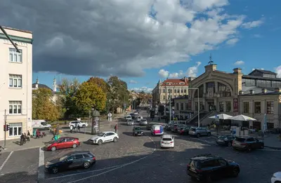 a city street filled with lots of parked cars at Alexa Old Town in Vilnius