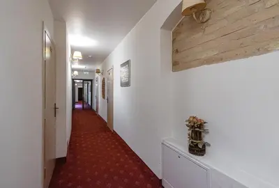 a hallway with a long red carpet and white walls at Alexa Old Town in Vilnius