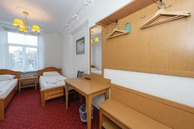 a hospital room with two beds and a table at Alexa Old Town in Vilnius