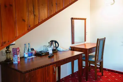 a wooden desk with a chair and a mirror at Galia in Druskininkai