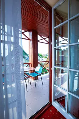 a room with a window and a table and chairs at Galia in Druskininkai