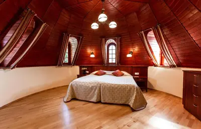 a bedroom with a bed in a room with windows at Galia in Druskininkai