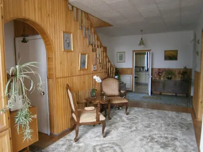 a hallway with a table and chairs in a room at Nemunas Tour Residence in Kaunas