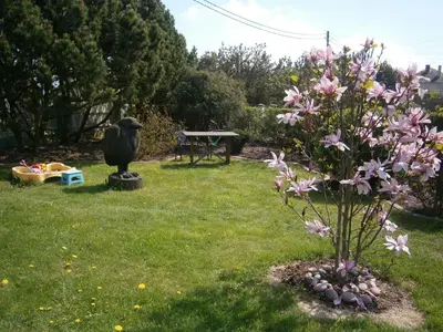 a garden with a statue of a bird and a picnic table at Nemunas Tour Residence in Kaunas